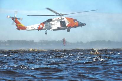 A student at the Aviation Technical Training Center (ATTC) in Elizabeth City, North Carolina, plunges from an Air Station Elizabeth City MH-60 Jayhawk helicopter into the Pasquotank River, Feb. 14, 2017. Four aviation survival technician (AST) A school students at ATTC graduated and became ASTs Feb. 17, 2017. (U.S. Coast Guard photo by Petty Officer 2nd Class Nate Littlejohn)