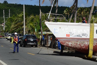 Hurricane Maria salvage crews remove wrecked boat from road in Fajardo, Puerto Rico