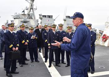 Capt. John Driscoll, commanding officer of U.S. Coast Guard Cutter Bertholf (WMSL 750), addresses officers from Japan coast guard on the ship’s flight deck Feb. 7, 2019. Bertholf is on a deployment to the Western Pacific Ocean in support of the U.S. Navy's 7th Fleet. U.S. Coast Guard photo by Chief Petty Officer John Masson